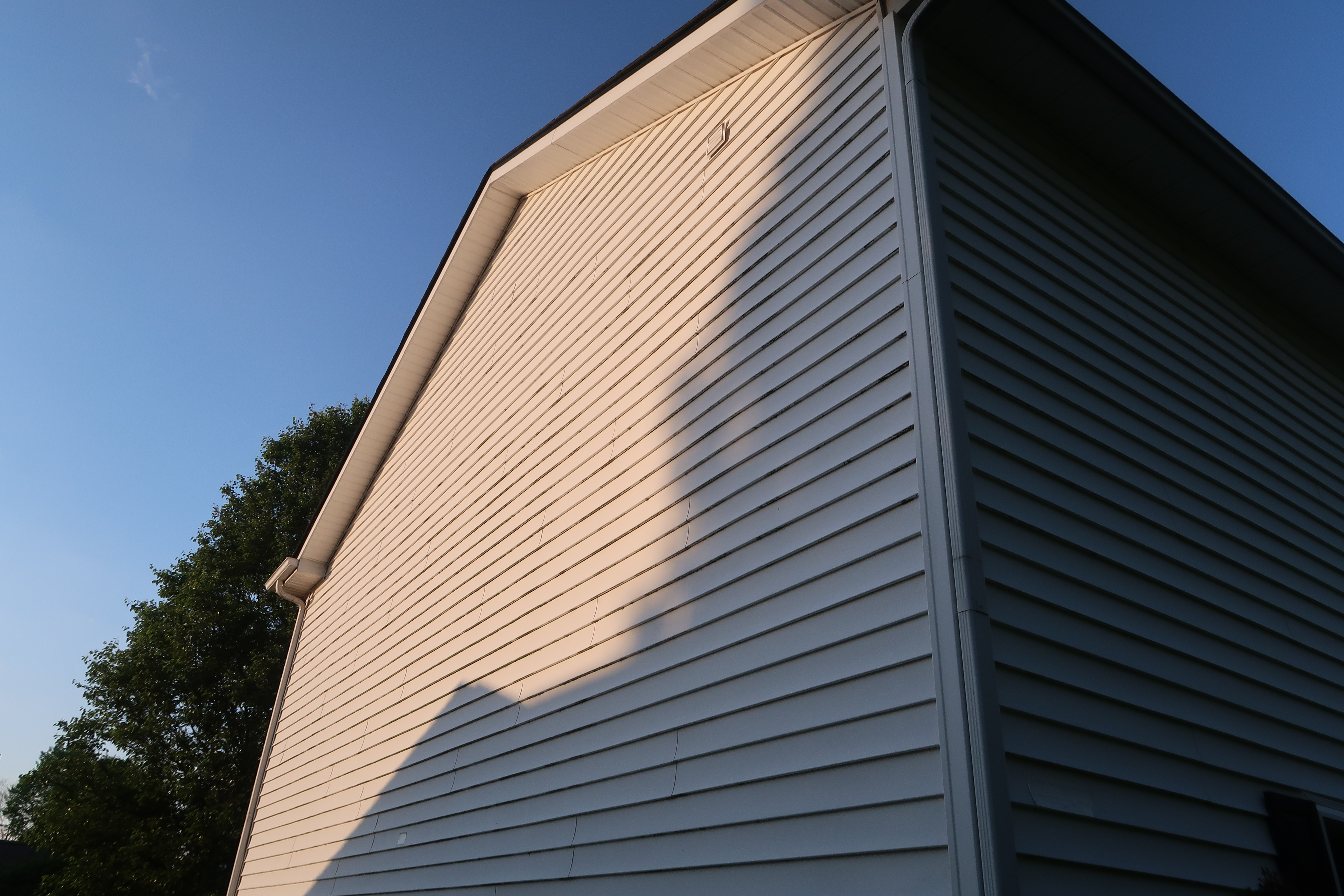 House siding corner before soft washing